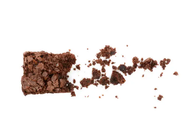 Homemade brownie and crumbs isolated on a white background
