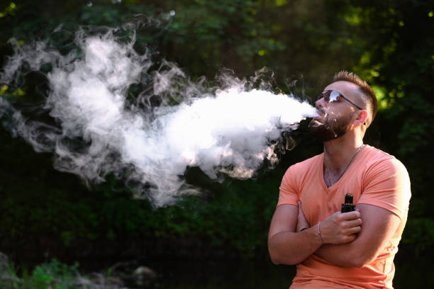 Vaper with beard with electronic cigarette Vaper with beard with electronic cigarette outdoor luckvape stock pictures, royalty-free photos & images