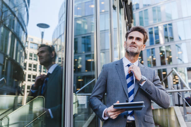 istock businessman in an office park with a tablet in the hand 887714812