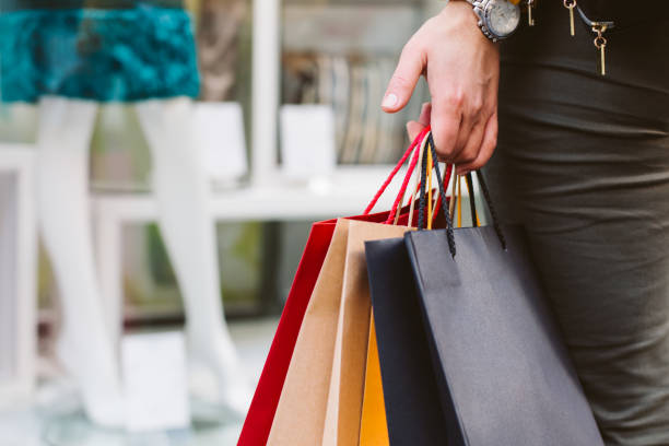 istock woman holding shopping bags 887715792