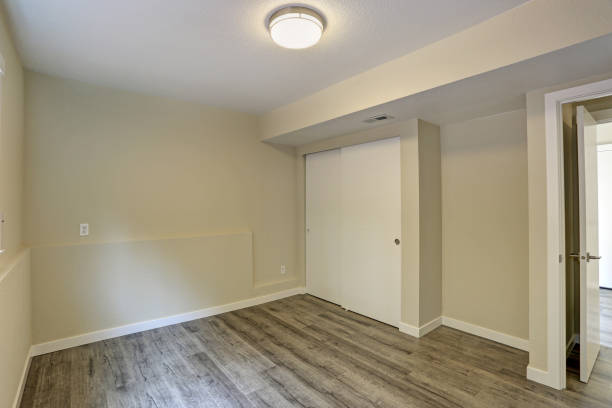 istock Bright beige empty room with grey hardwood floor 887732046