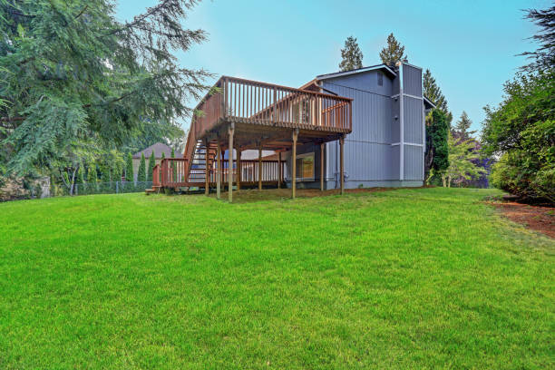 istock Backyard view of grey rambler house with upper and lower decks 887732338
