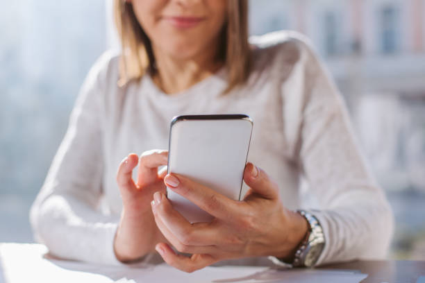 istock woman holding a mobile phone 887739986