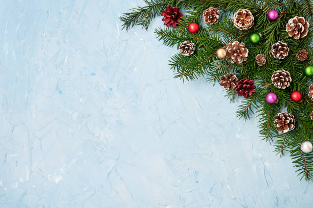 istock Christmas fir tree branches with decoration on blue background. Copy space 887749292