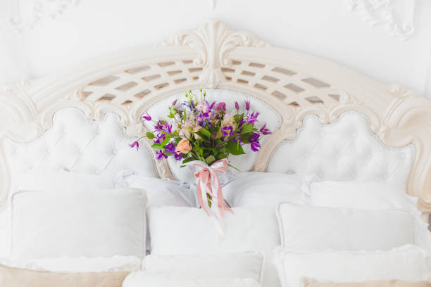 istock Among the pillows is a bouquet of the bride. 887749346