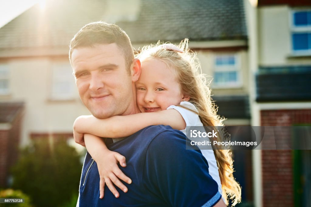 Day out with me and daddy Portrait of a cheerful young father giving his daughter a piggyback ride while looking at the camera outside Ireland Stock Photo