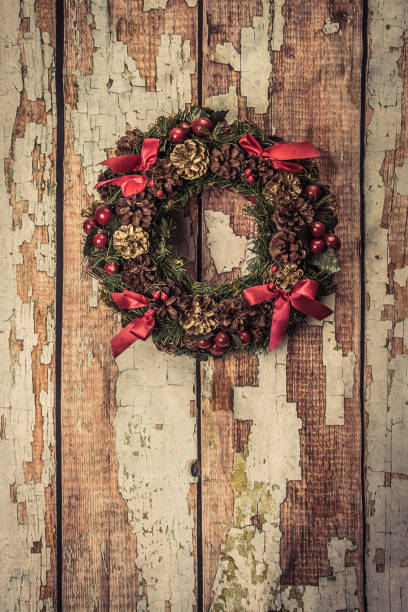 istock christmas wreath on wood background 887753994