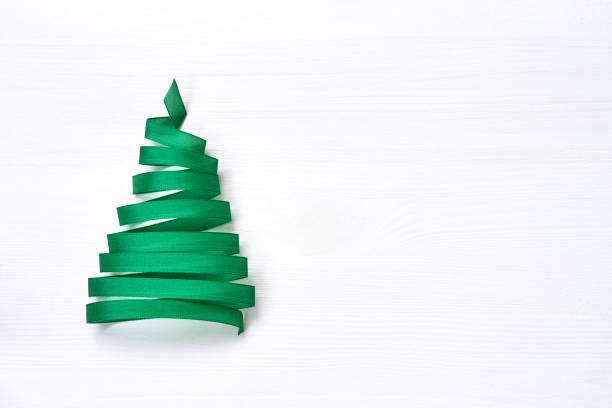 istock Christmas tree made from green ribbon on white background. Copy space 887762554