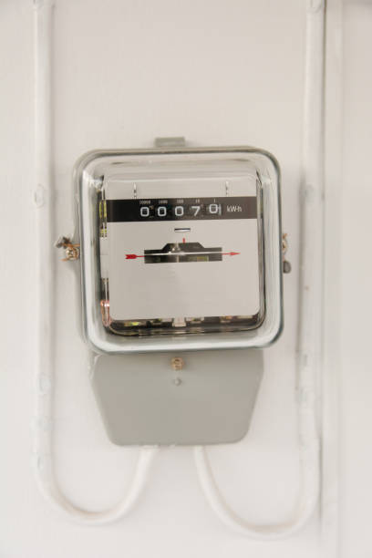 istock Analog electric meter on cement wall. Electricity consumption concept. 887762734