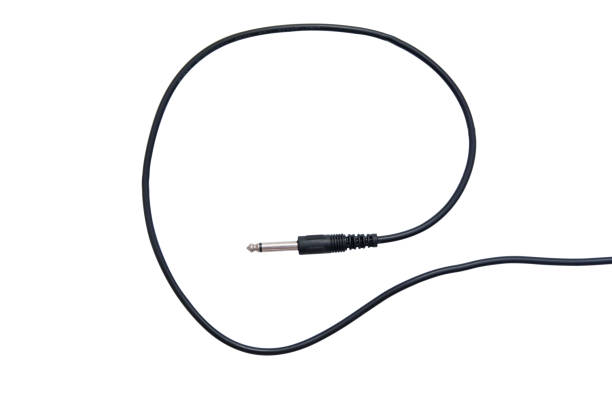 istock Guitar audio jack with black cable isolated on white background 887766038