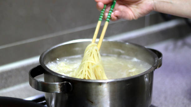 istock Boil the noodles first of all. 887768844