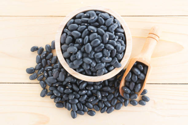 istock black-beans in wood cup on sack background 887784520