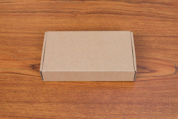 istock Empty brown cardboard box or tray for mock up on the wooden table with copy space. 887806616