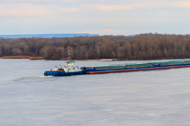 istock Tugboat pushing a heavy long barge on the river Dnieper 887806988