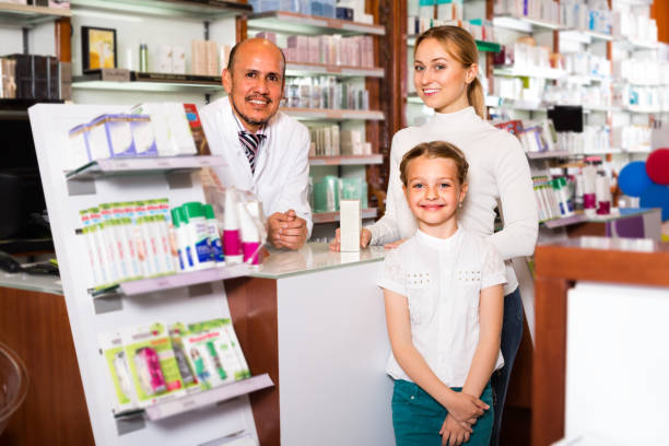 istock pharmacist standing with a cash desk 887807384