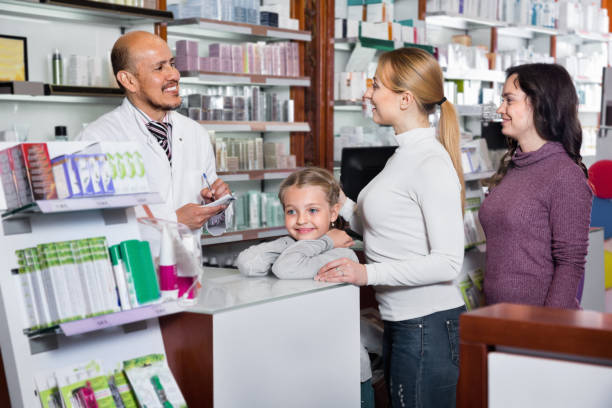 istock Male pharmacist working pharmaceutical store and consulting customers 887807414