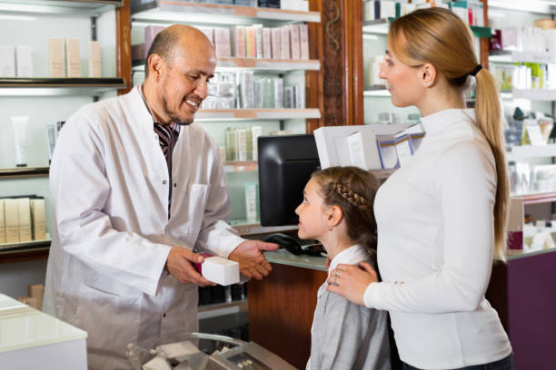 istock Male pharmacist working pharmaceutical store and consulting customers 887807428