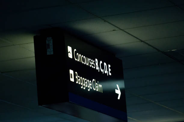 istock concourse sign and directional arrows at an airport 887809848