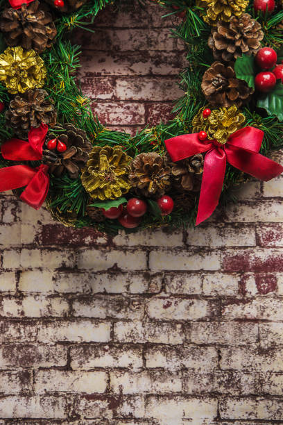 istock christmas wreath on  brick wall background . 887812190