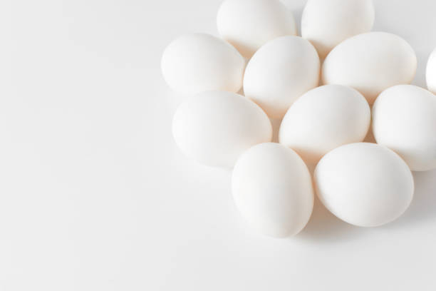 istock White eggs on a white background. Easter photo concept. Copy space. View from above. 887812436