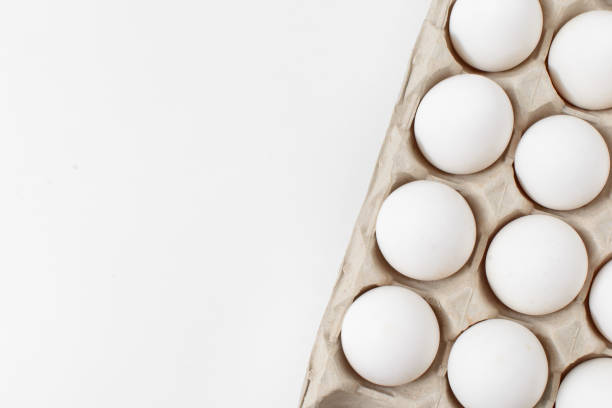 istock White eggs in craft package on a white background. Easter photo concept. Copy space. View from above. 887812438