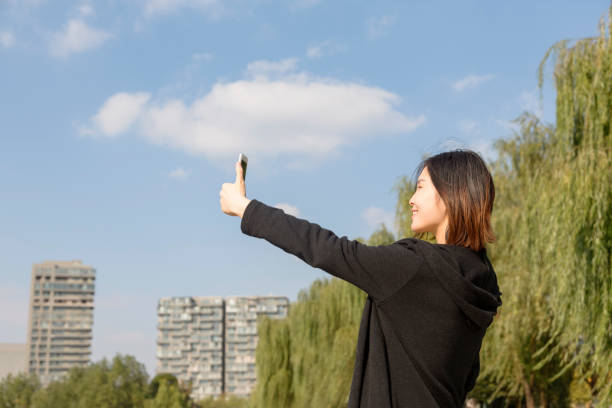 istock pregnant woman taking selfie on bridge 887812780