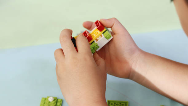 istock The hands of a child playing with blocks. 887820040