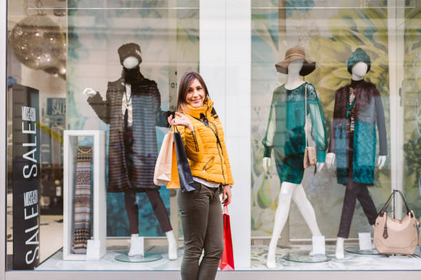 istock woman holding shopping bags 887822502