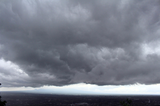 The view of Prambanan as seen from top and far-away during rainy and cloudy day. A volcano as the background. Pic was taken in November 2017.