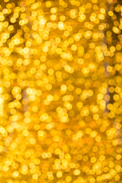 istock blured Christmas light  on gold abstract lights bokeh background 887846780
