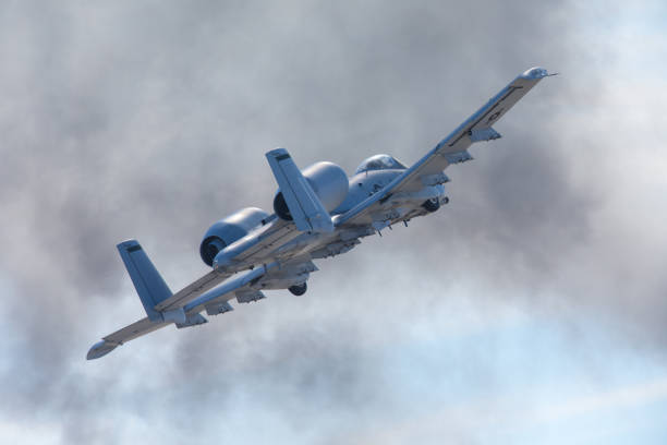 Airplane going through smoke Airplane going through smoke warthog stock pictures, royalty-free photos & images