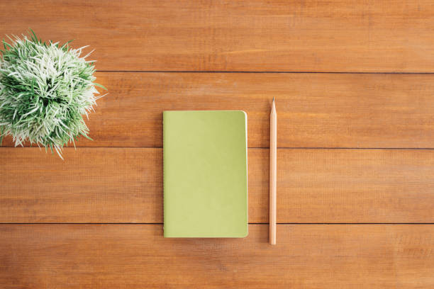 istock Minimal work space - Creative flat lay photo of workspace desk. Office desk wooden table background with open mock up notebooks and pens and plant. Top view with copy space, flat lay photography. 887870790