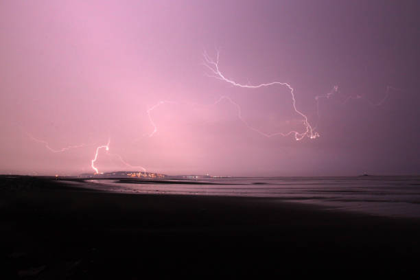 istock Electric storm in the beach, sand clouds and thunders. 887885452