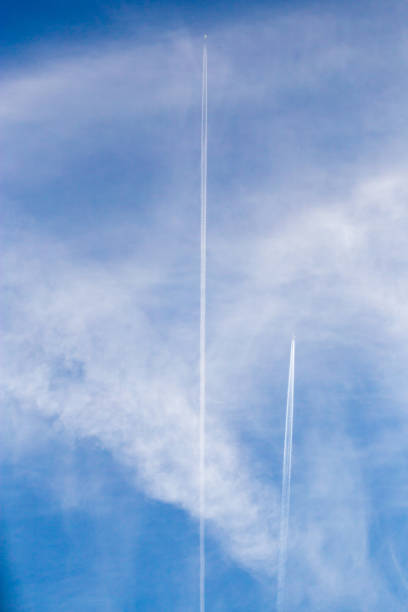istock traces of an airplane on a blue sky 887886290