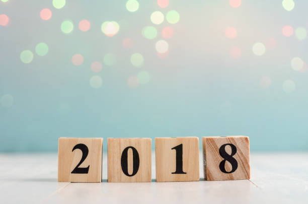 istock Wooden cube with 2018 label for new year decoration on bokeh background 887890900
