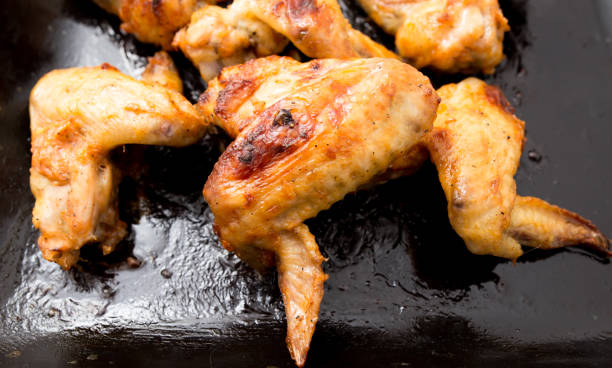 istock Juicy fried chicken wings in the oven 887898478