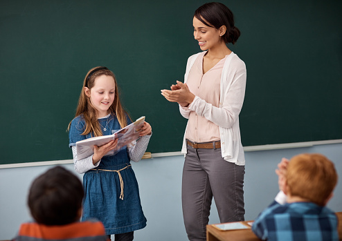 Teacher reading to her elementary school students