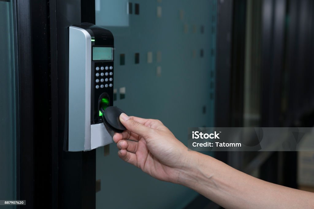 young woman using RFID tag key to open the door Accessibility Stock Photo