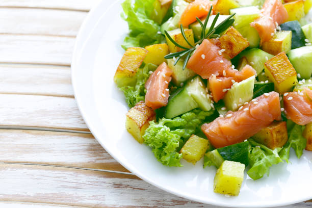 istock salad with red fish, potatoes and fresh cucumbers 887920124