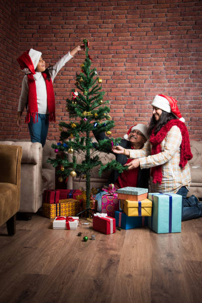 istock indian family celebrating christmas and decorating tree 887921456