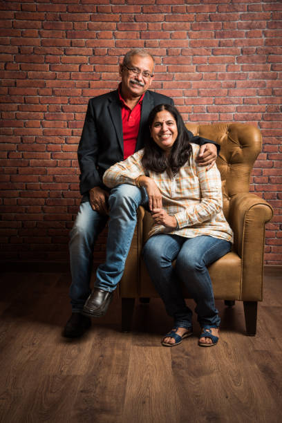 indian gold couple sitting on sofa