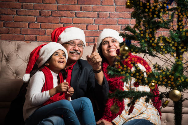 istock indian family celebrating christmas and decorating tree 887942508