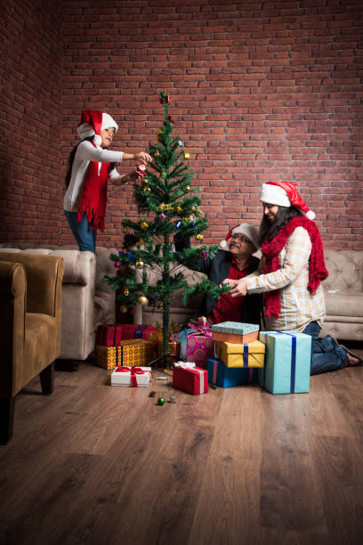 istock indian family celebrating christmas and decorating tree 887944590
