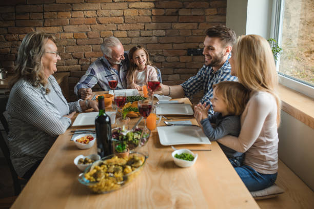 istock Happy multi-generation family having lunch at dining table. 887949562