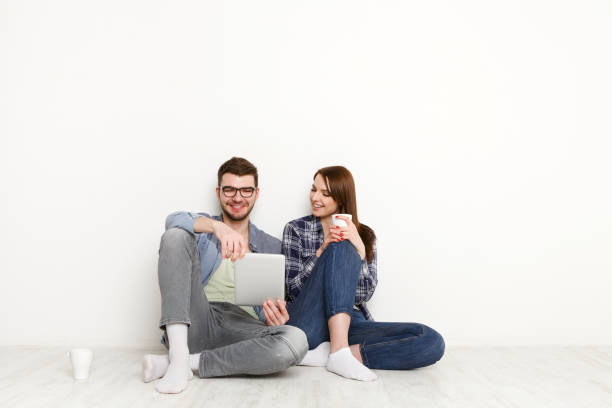 istock Smiling couple web-surfing on tablet, studio shot 887960104