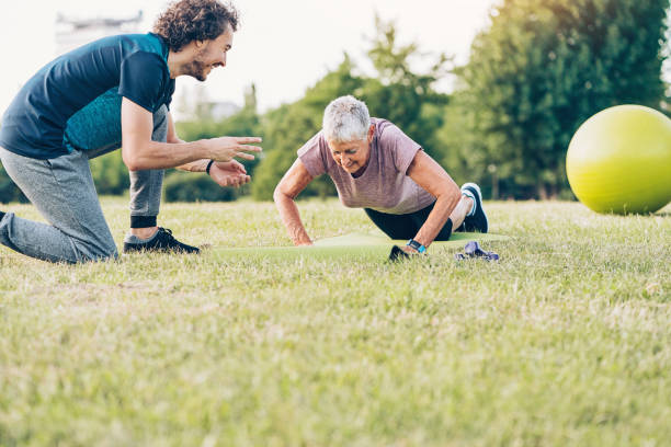 istock Senior woman making push-ups in the park 887964866