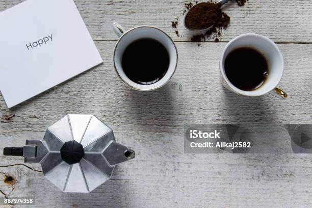 Happy Coffee Time Top View Of Two Coffee Cups Italian Coffee Makermoka And White Card With Happy Text Stock Photo - Download Image Now