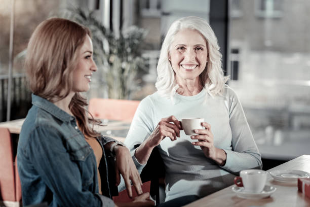istock Happy elderly woman spending time with her attentive granddaughter 887977466