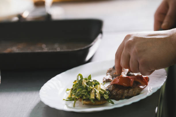 istock Chef serves steak on the plate in restaurant 887981340