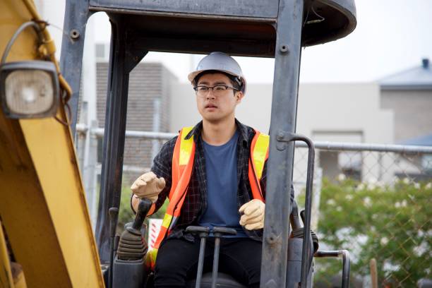 istock SYD112017 Chinese male construction worker driving machinery 887982004